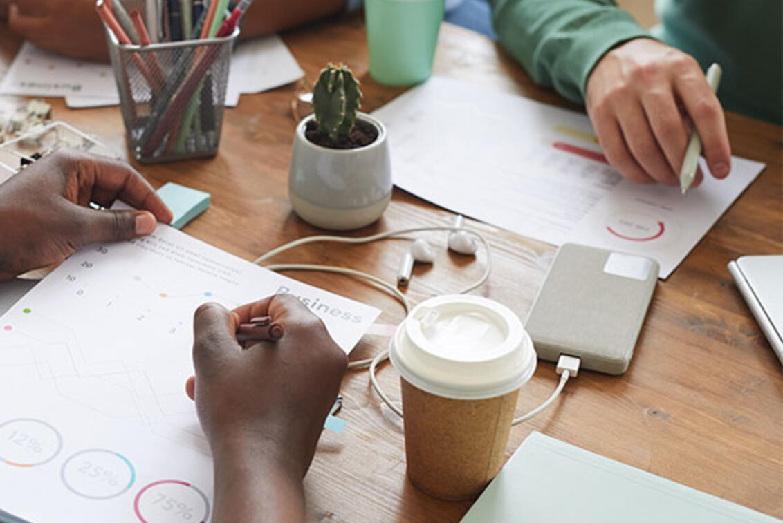 Students writing on a desk.