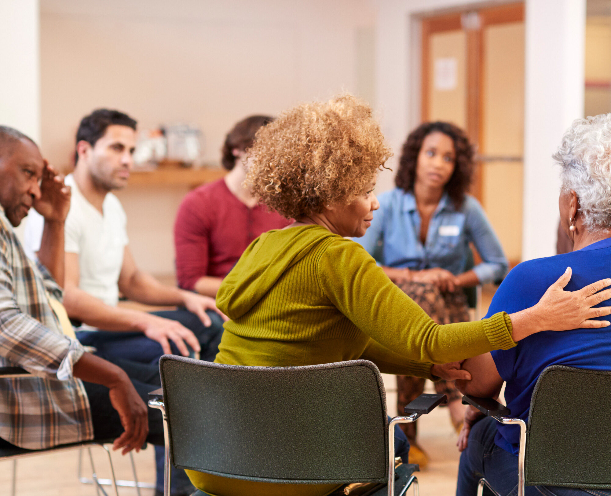 A group of people of different ages participating in a discussion session